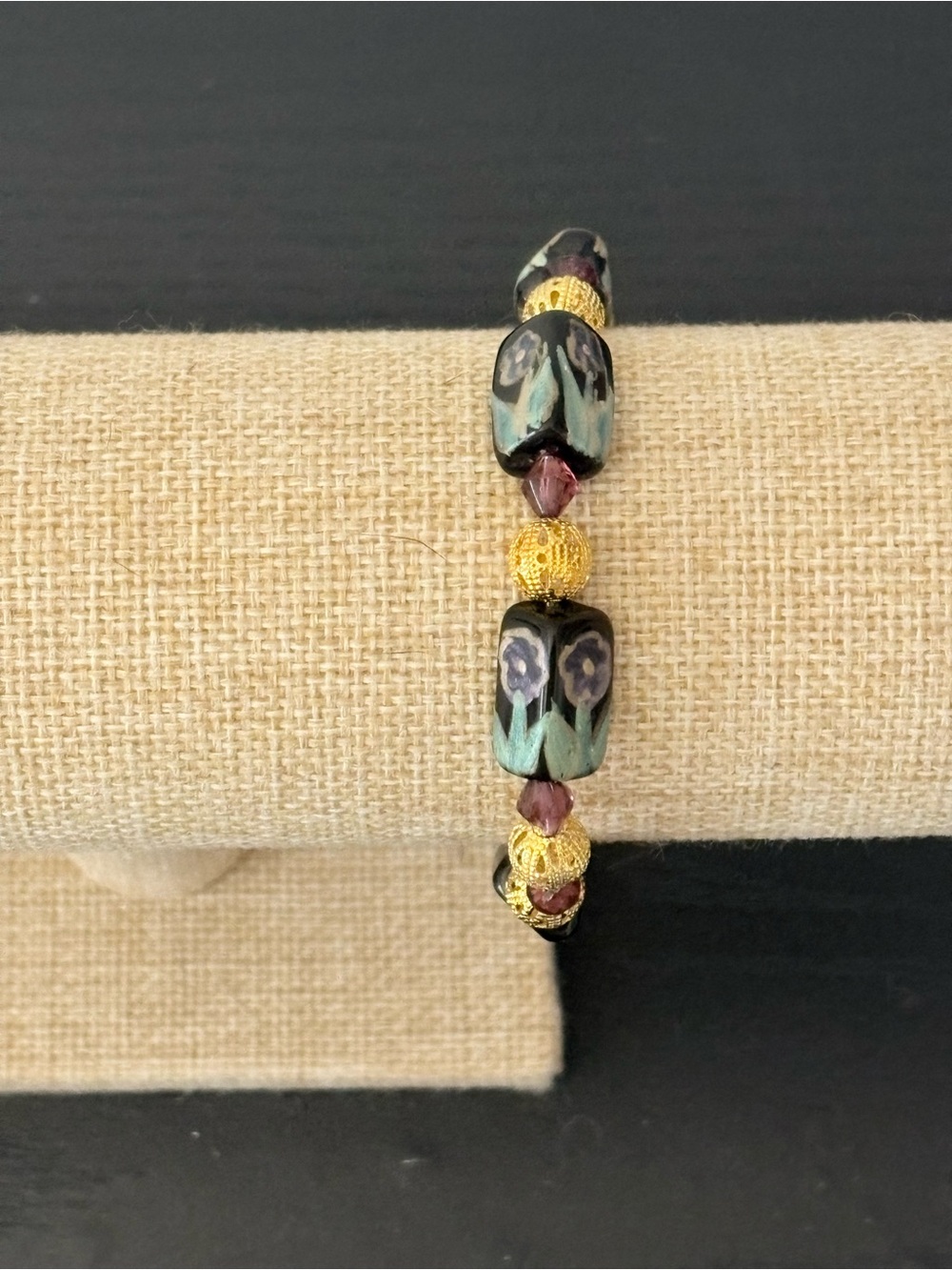 Handcrafted black floral glass bead with gold round filigree beaded bracelet